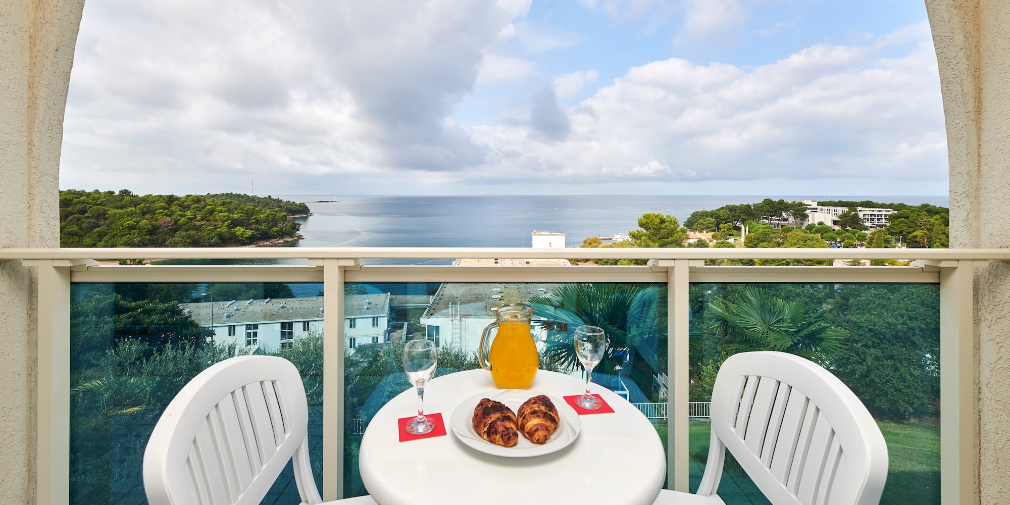 a table with food and drinks on it overlooking a body of water
