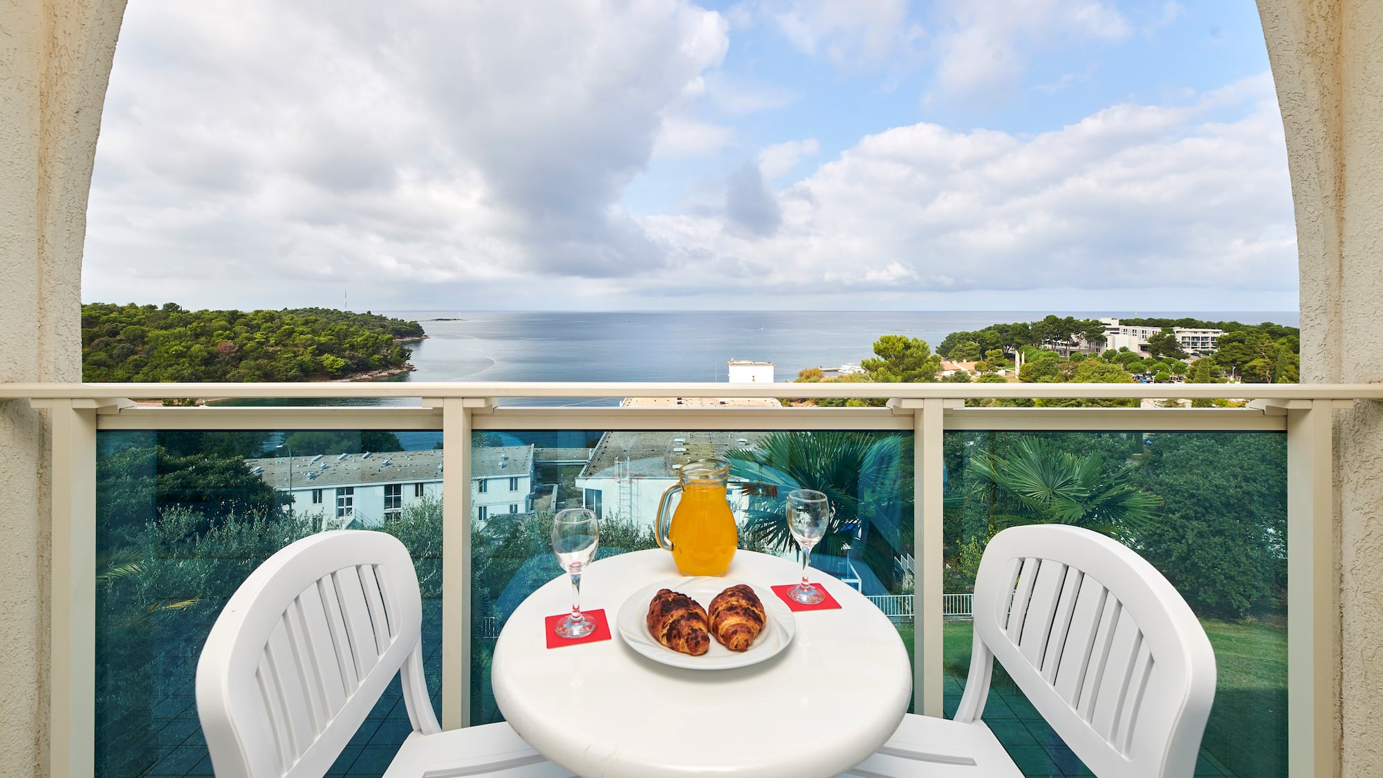 a table with food and drinks on it overlooking a body of water