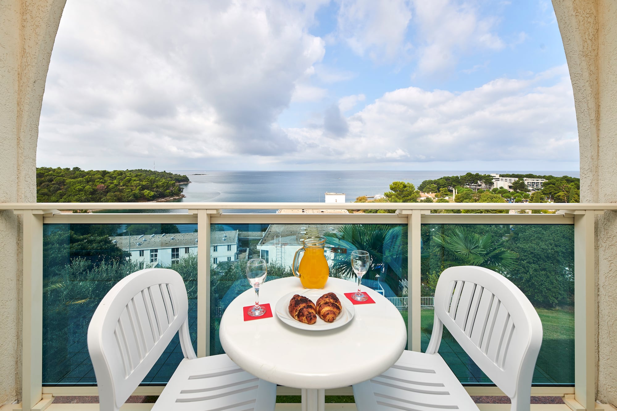 a table with food and drinks on it overlooking a body of water
