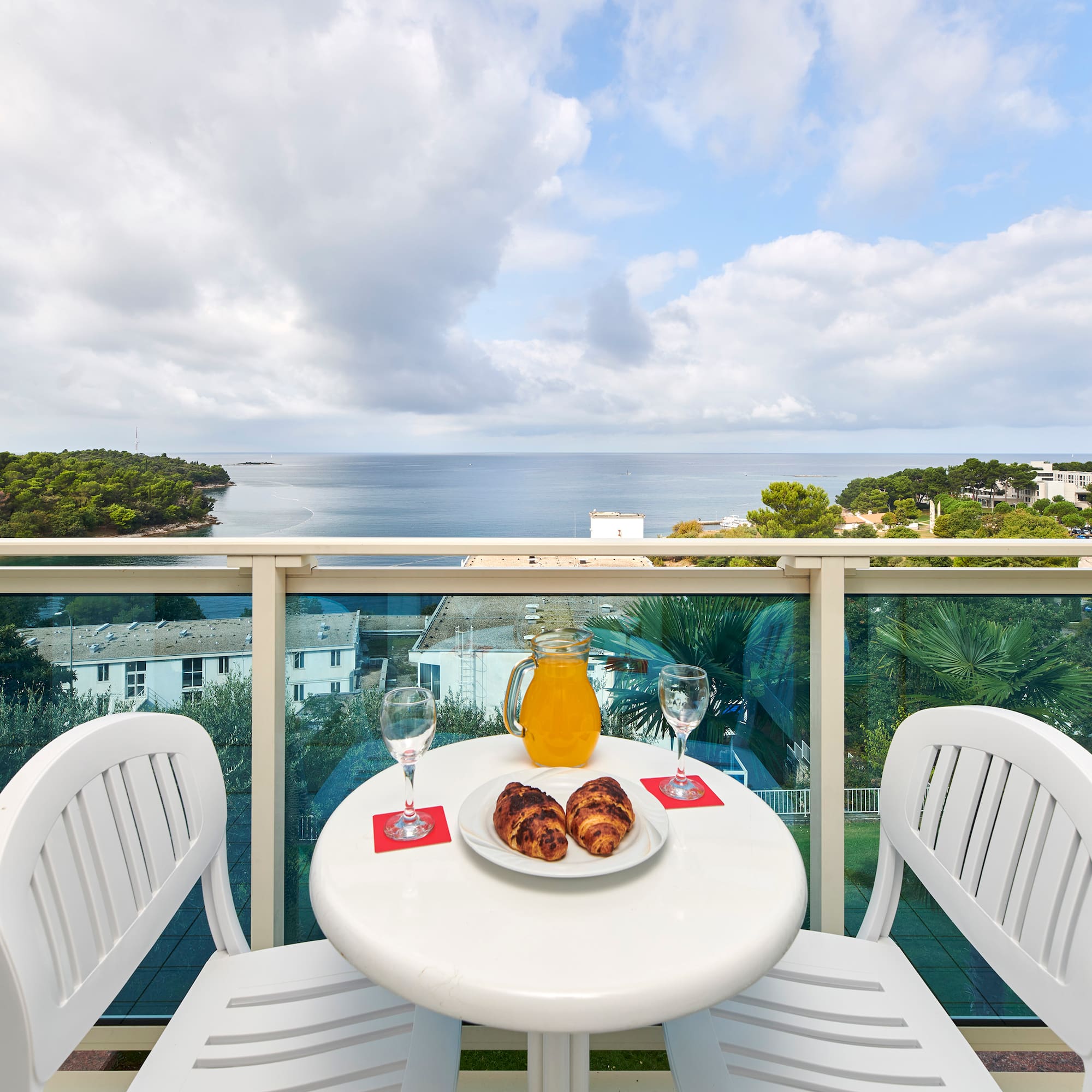 a table with food and drinks on it overlooking a body of water