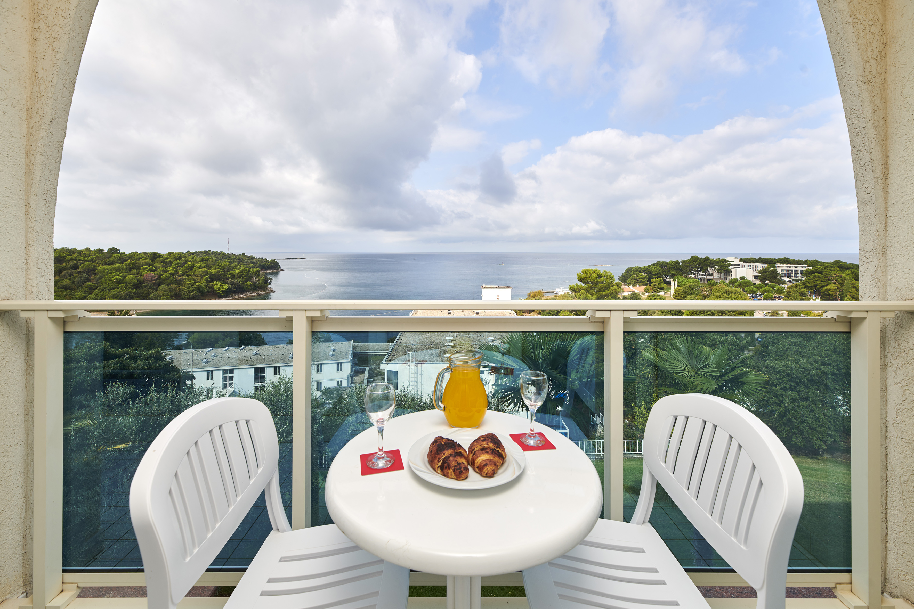 a table with food and drinks on it overlooking a body of water