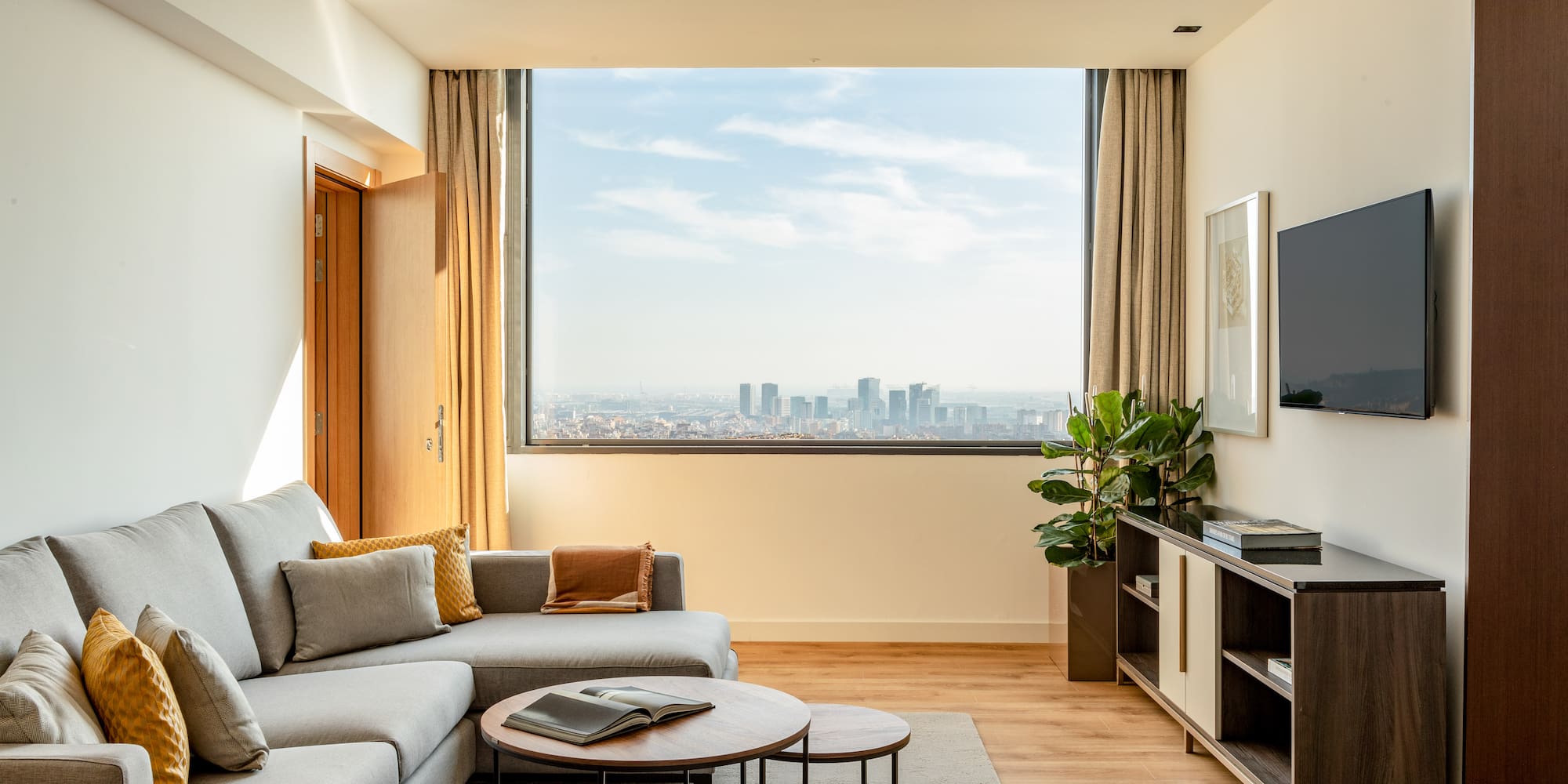a living room with a large window and a couch