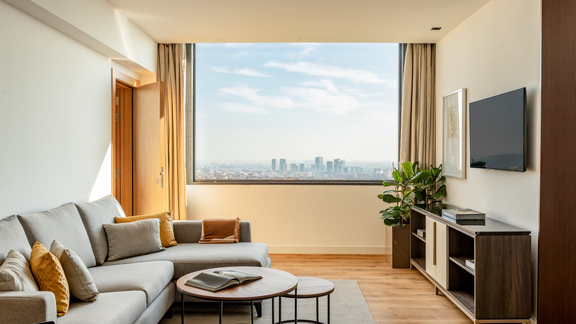 a living room with a large window and a couch