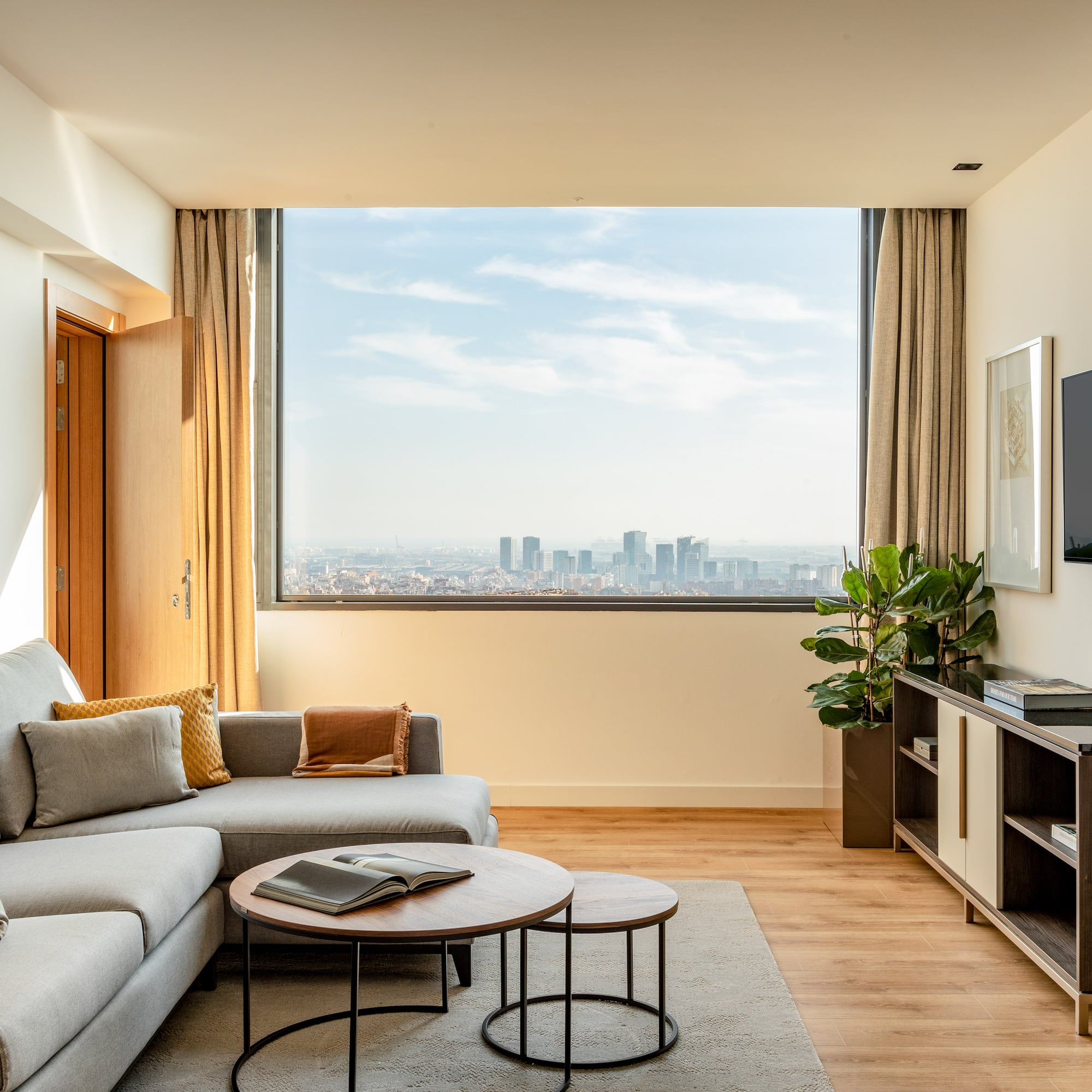 a living room with a large window and a couch