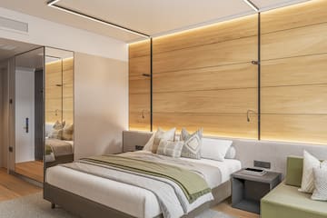 a bedroom with a mirror and a bed