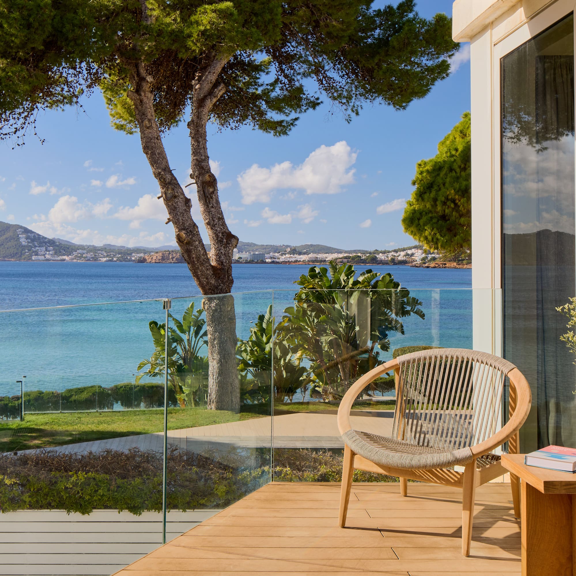 a chair on a deck overlooking a body of water