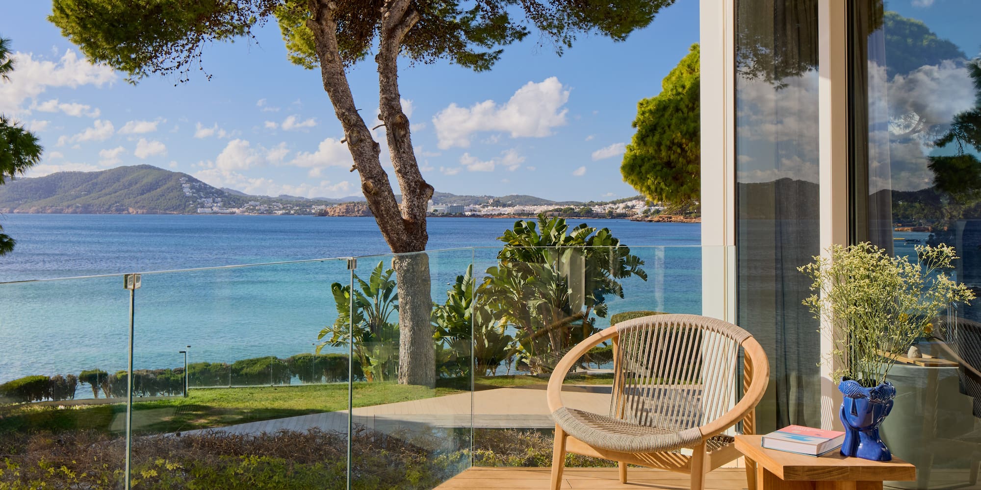 a chair on a deck overlooking a body of water