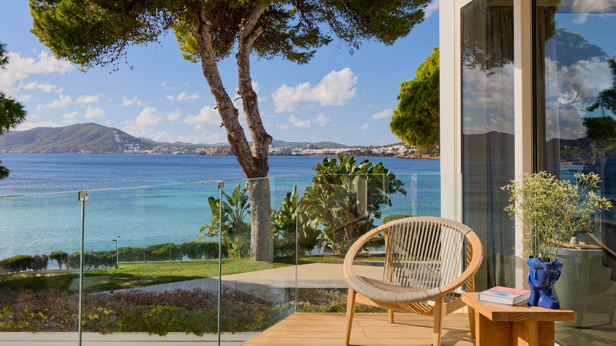 a chair on a deck overlooking a body of water