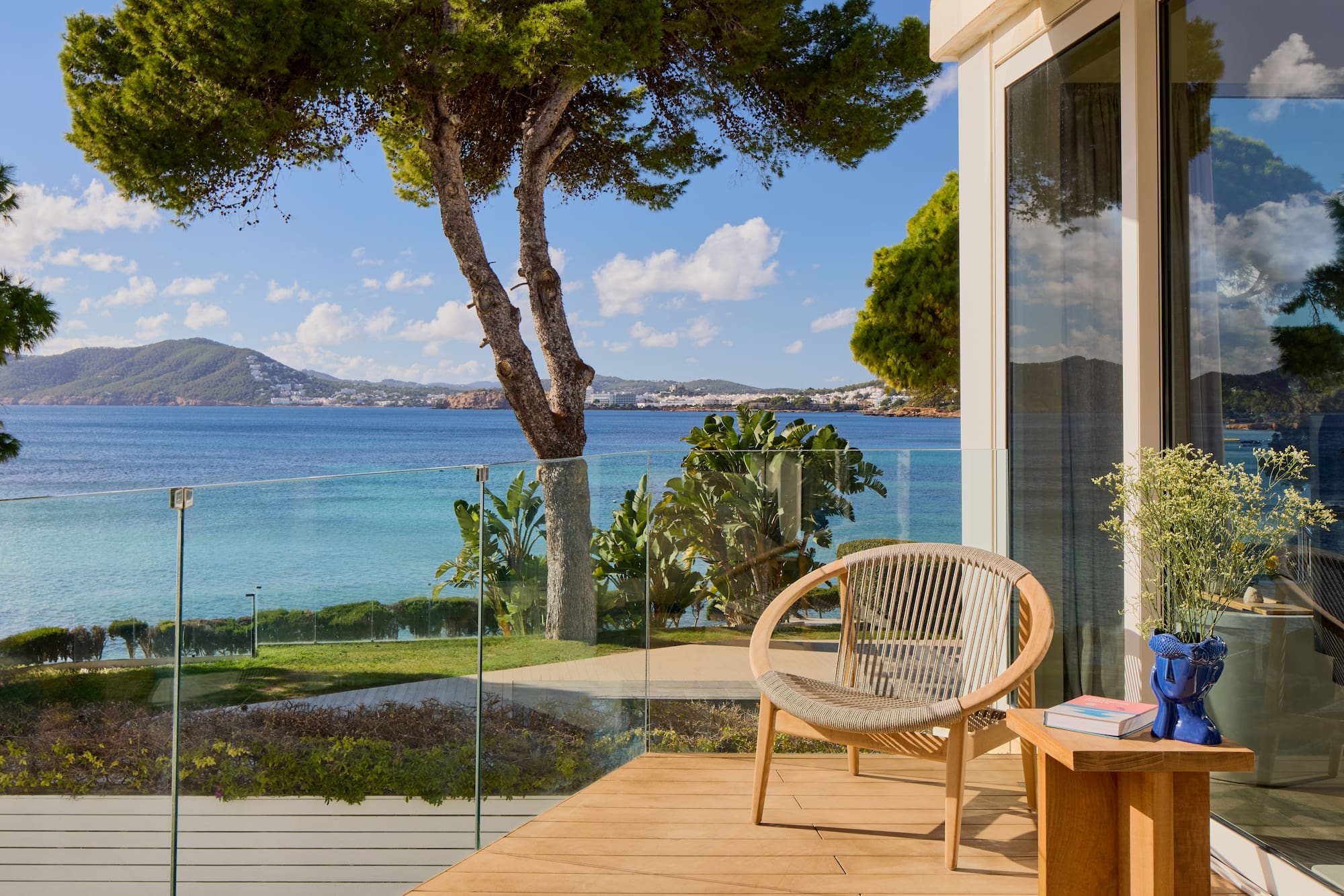 a chair on a deck overlooking a body of water