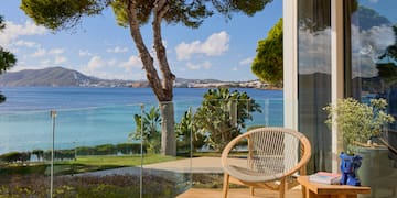 a chair on a deck overlooking a body of water