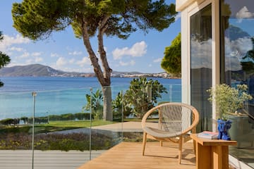 a chair on a deck overlooking a body of water