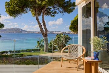 a chair on a deck overlooking a body of water