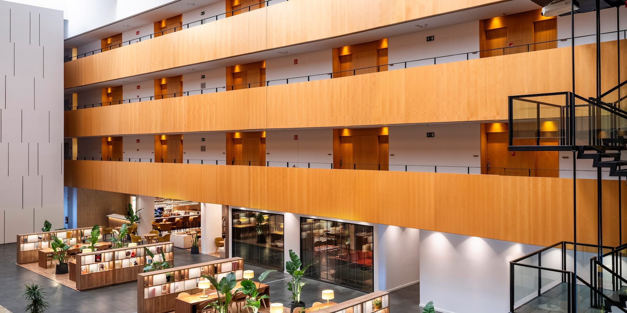 a large building with a large balcony and tables