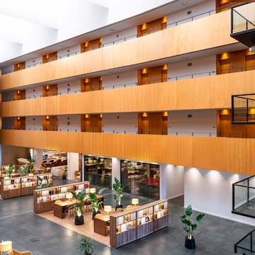 a large building with a large balcony and tables