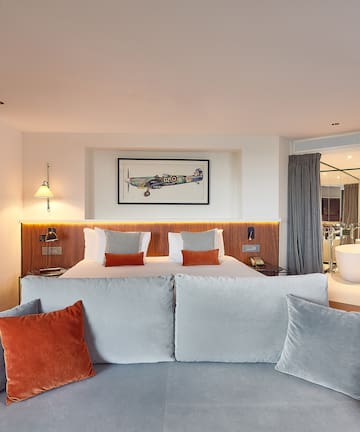 a room with a bed and a bathtub