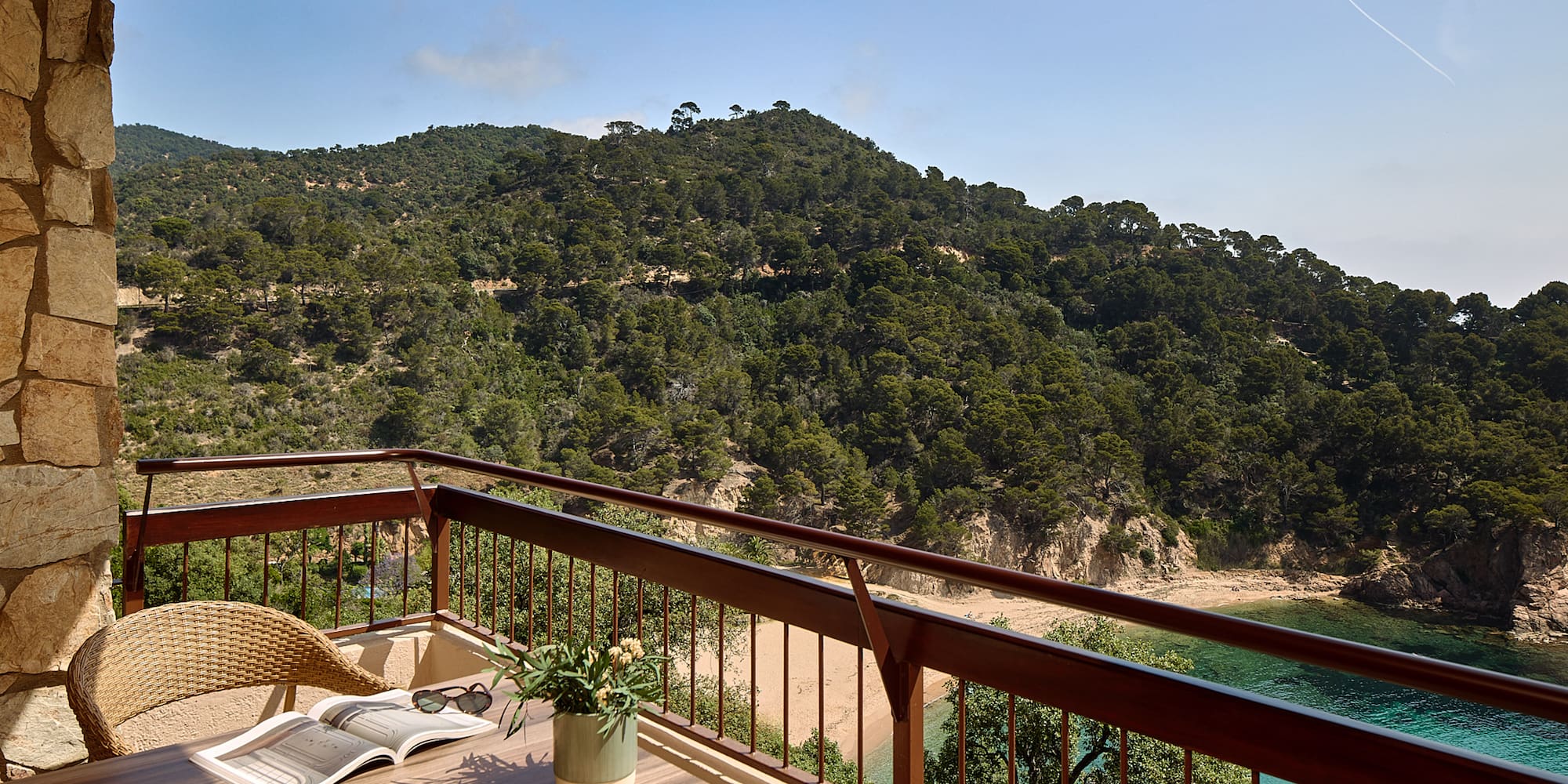 a balcony with a table and chairs and a book on it