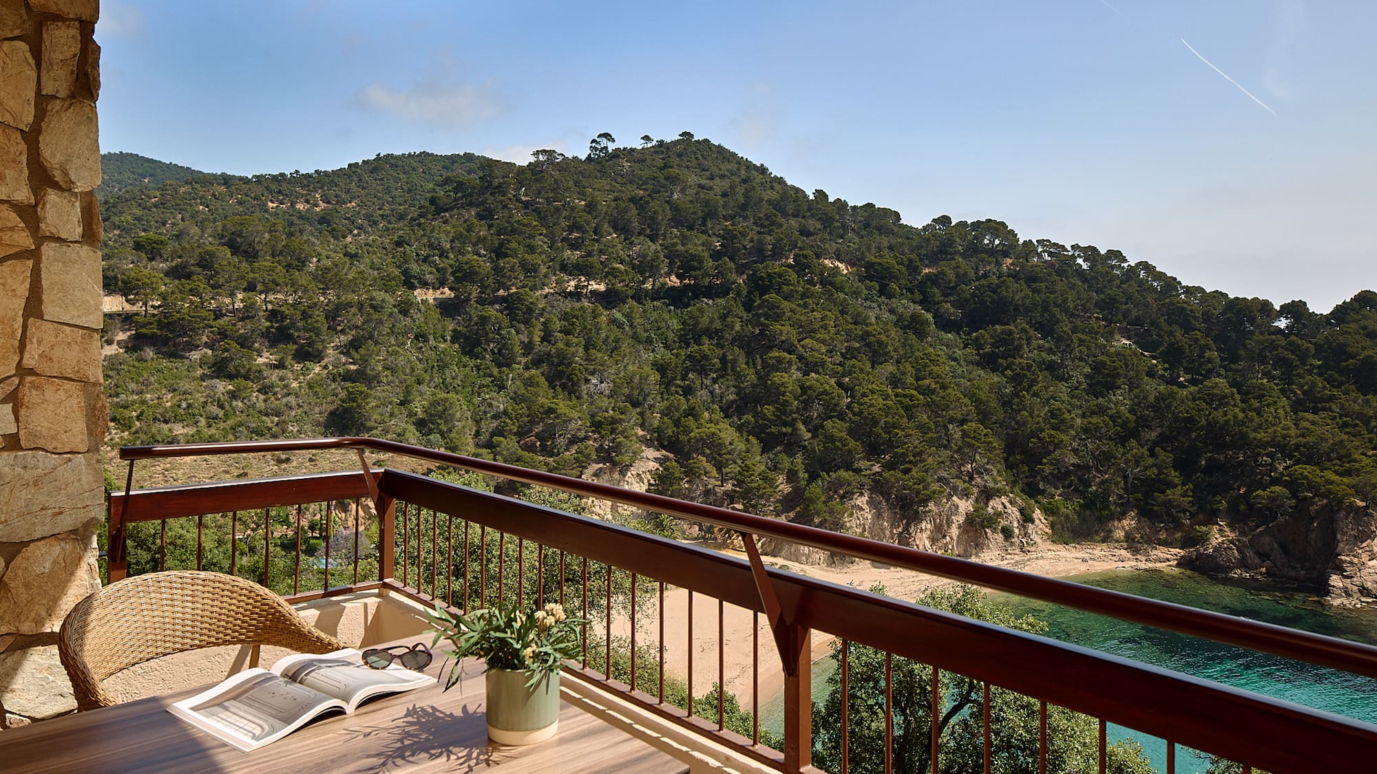 a balcony with a table and chairs and a book on it