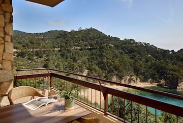 a balcony with a table and chairs and a book on it
