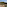 Scenic balcony with Mediterranean sea view, forested hills, and sandy beach.