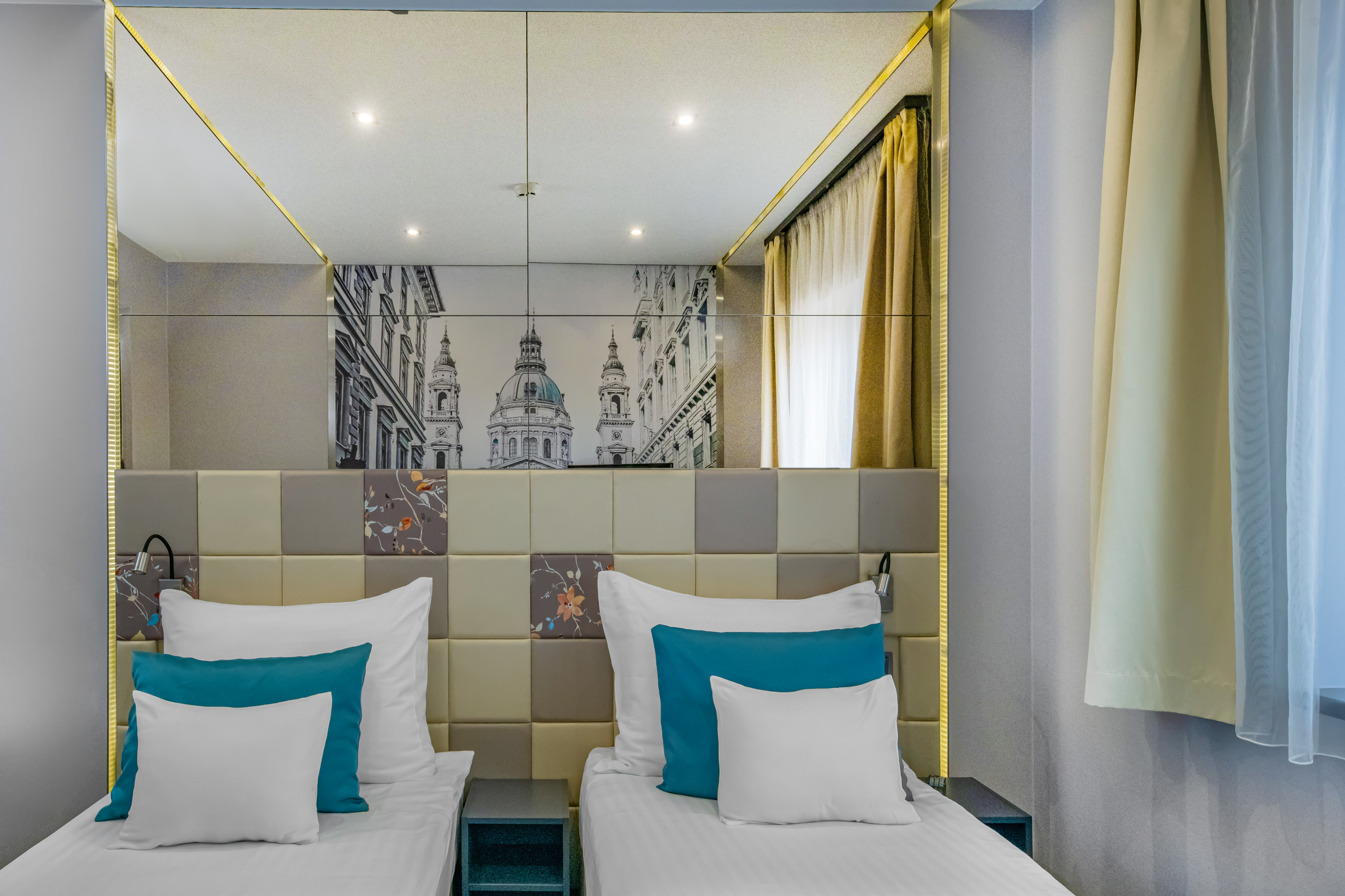 Modern hotel twin room, mirrored headboard with city scape, teal pillows. - Standard - Hotel President Budapest Affiliated by Meliá, Budapest