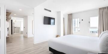 a room with a bed and a television