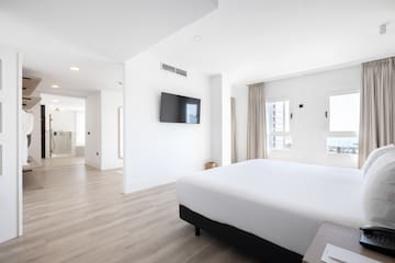a room with a bed and a television