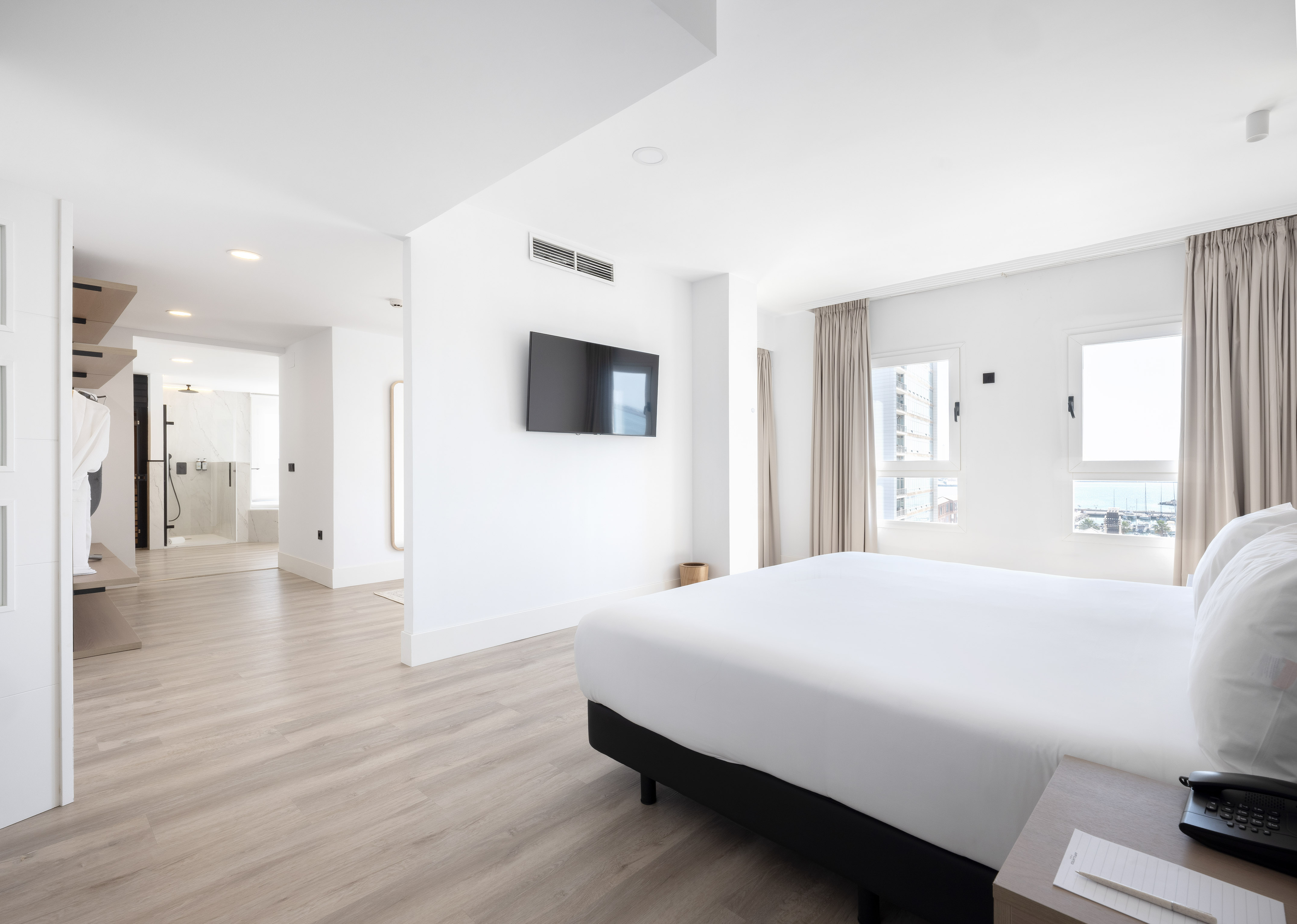 a room with a bed and a television