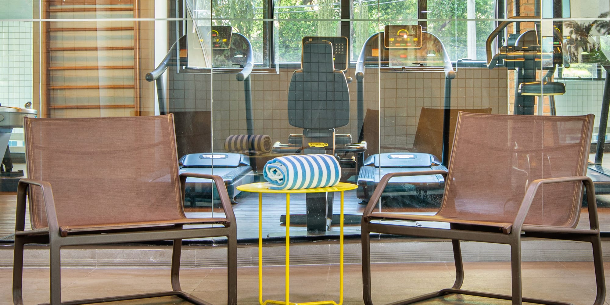 a room with chairs and a pool