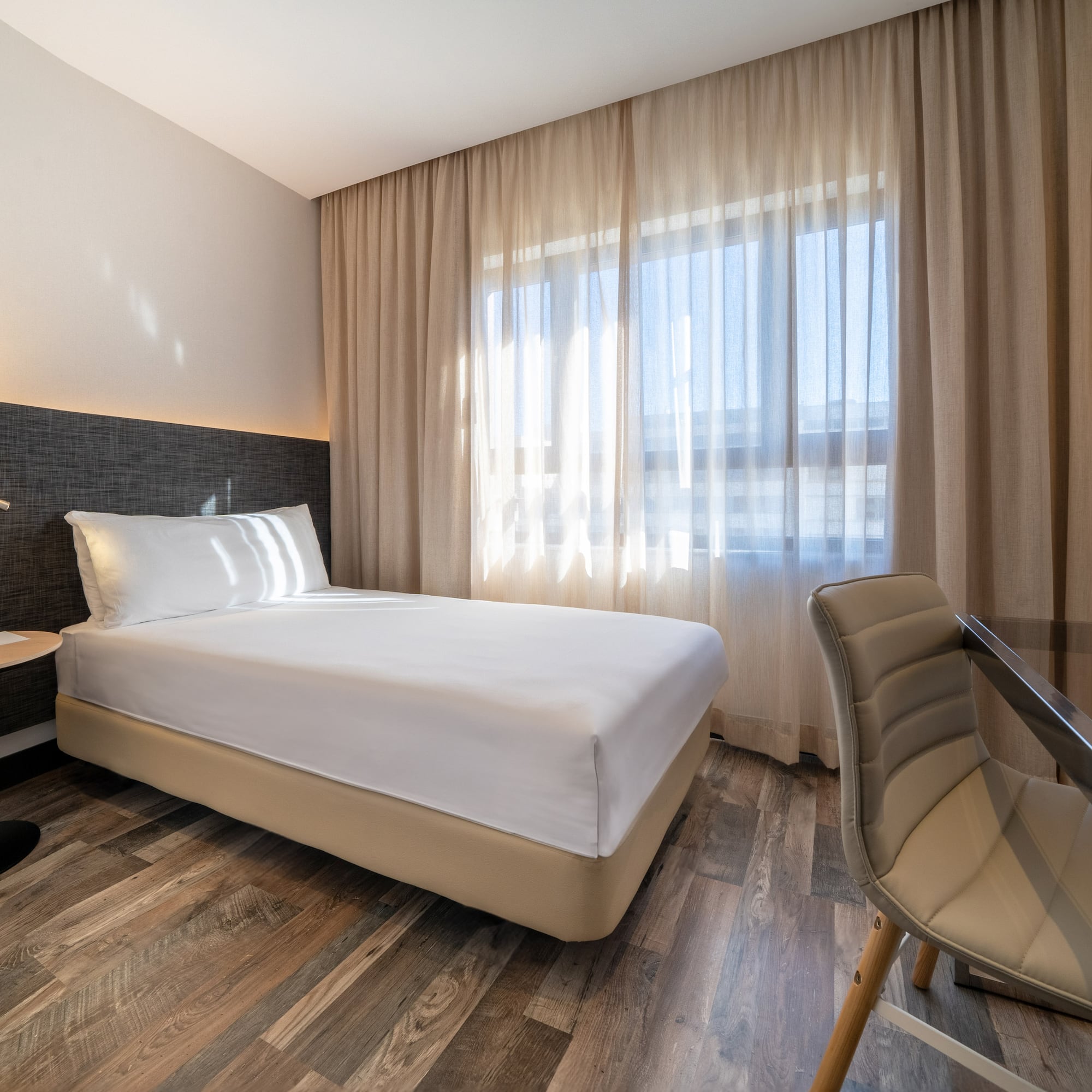 a room with a bed and a chair