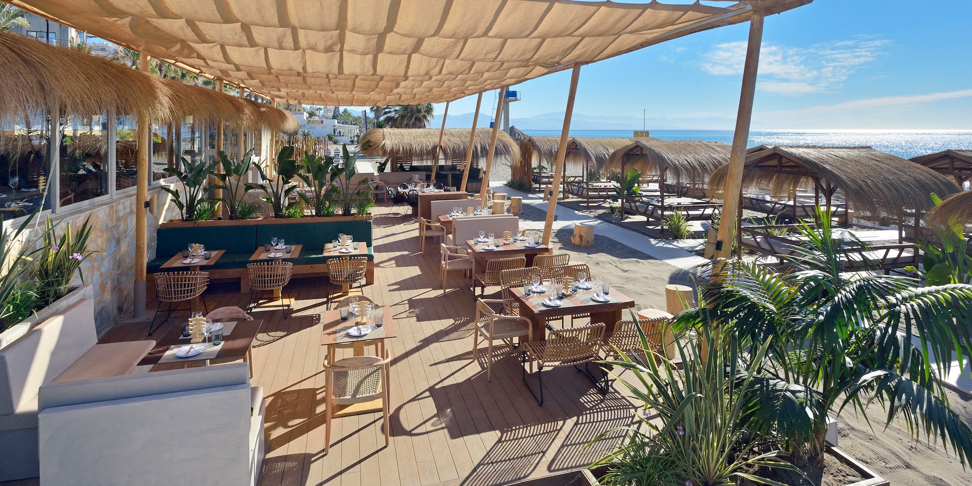 a restaurant with tables and chairs on a deck