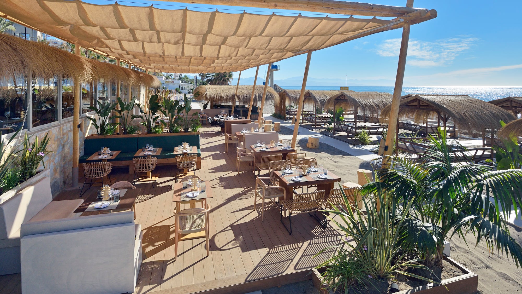 a restaurant with tables and chairs on a deck