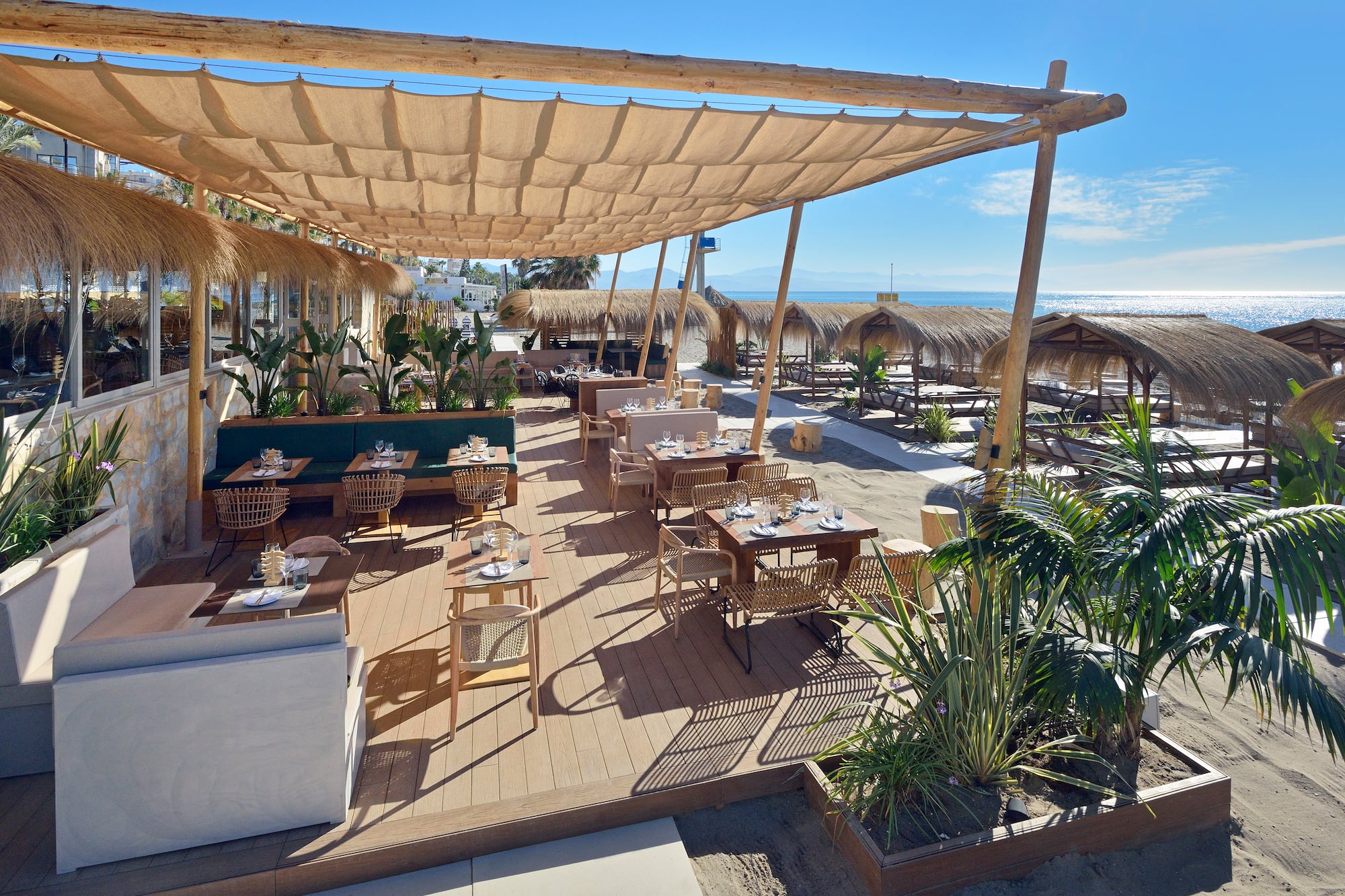 a restaurant with tables and chairs on a deck