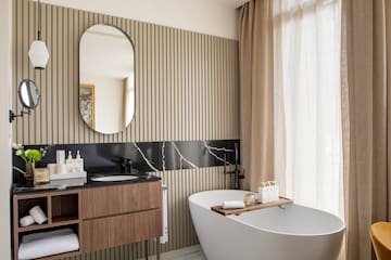 a bathroom with a tub and a mirror