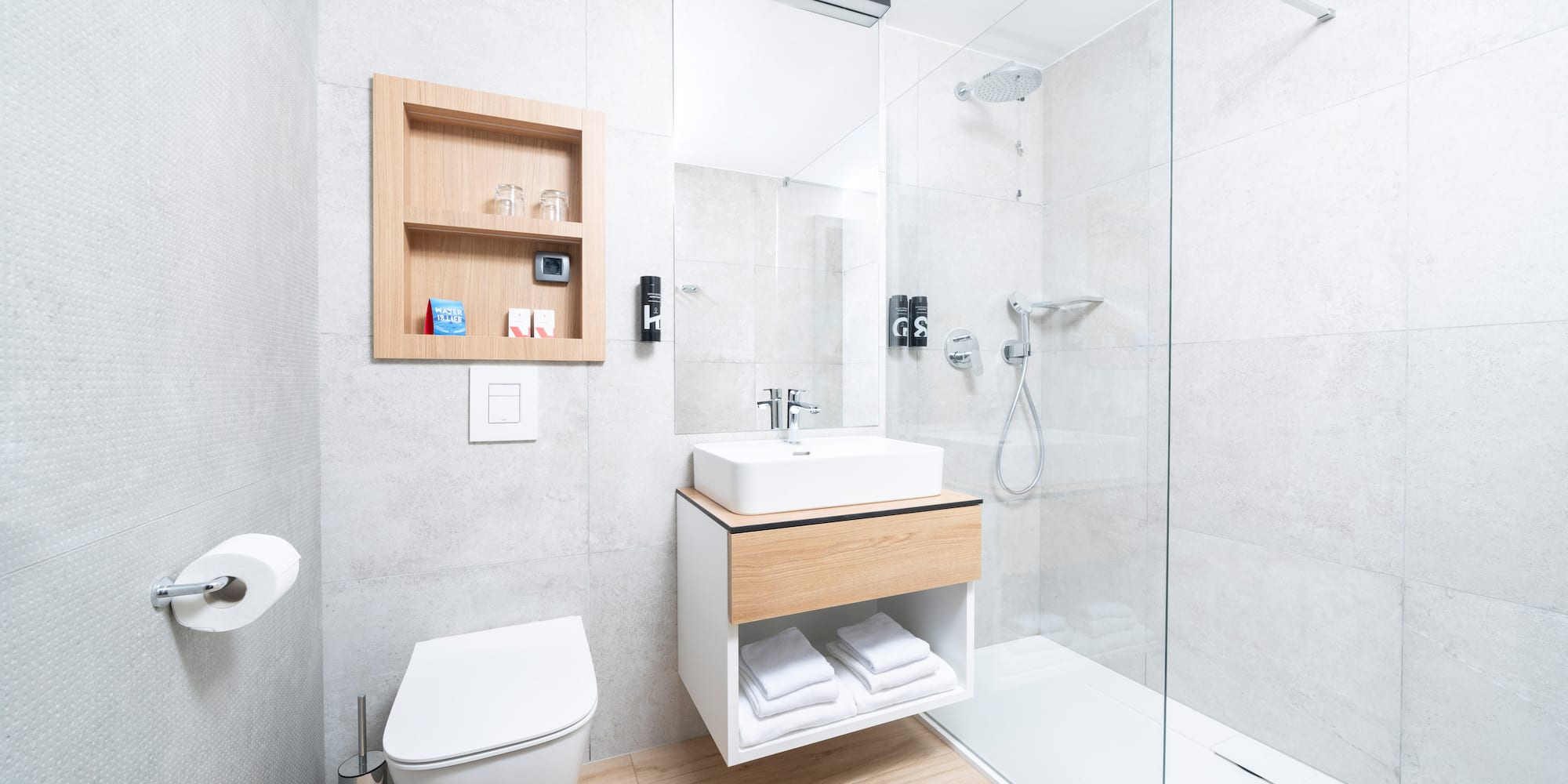 a bathroom with a glass shower and sink