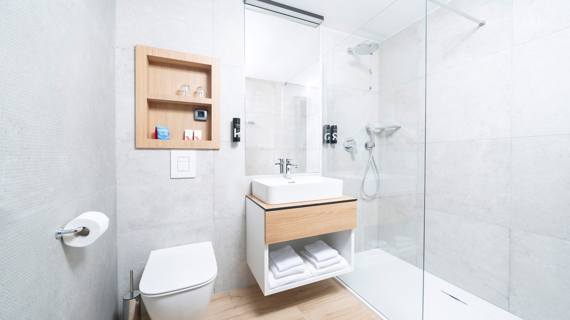 a bathroom with a glass shower and sink