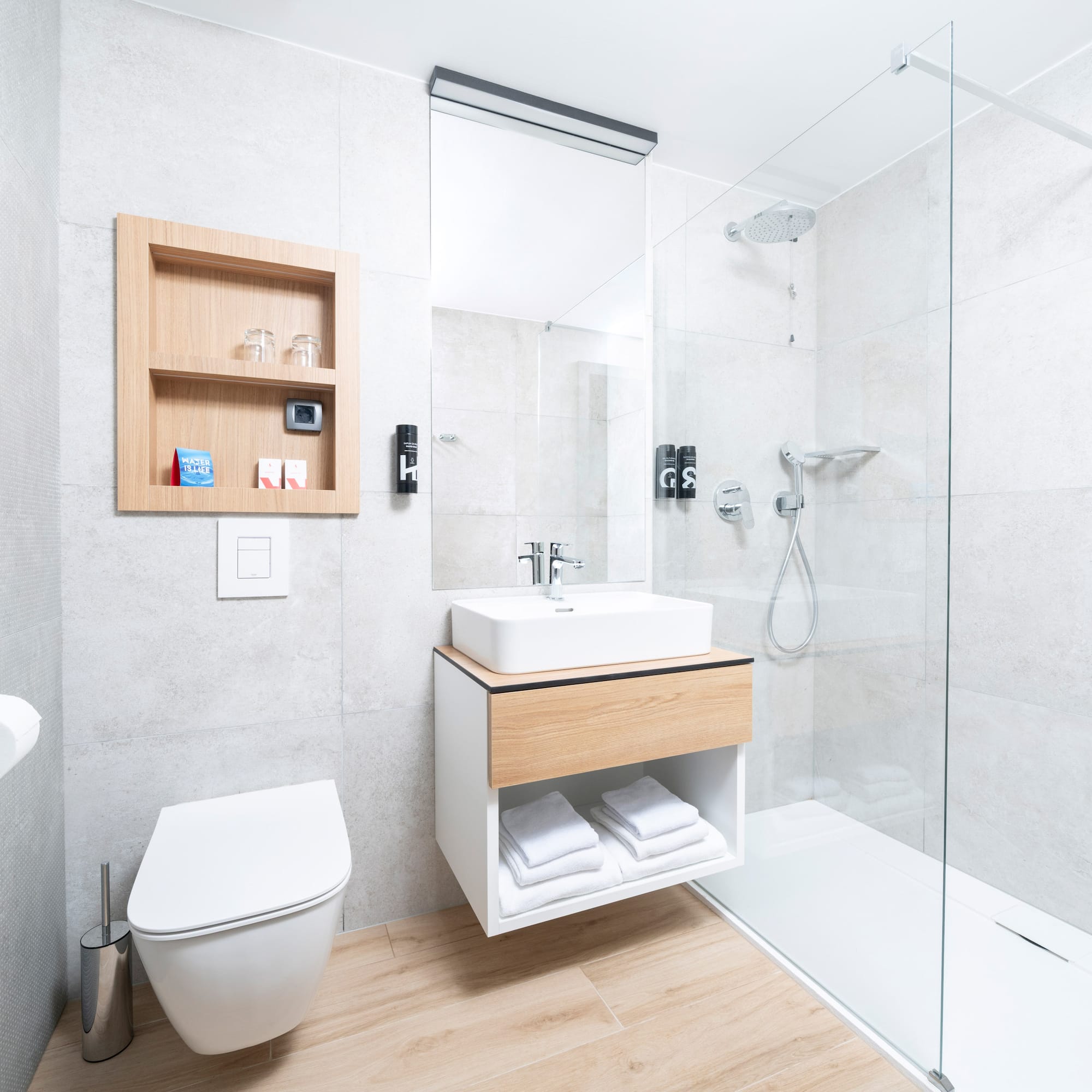 a bathroom with a glass shower and sink