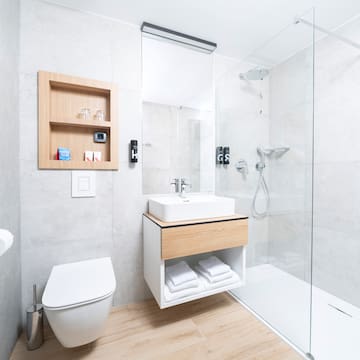 a bathroom with a glass shower and sink