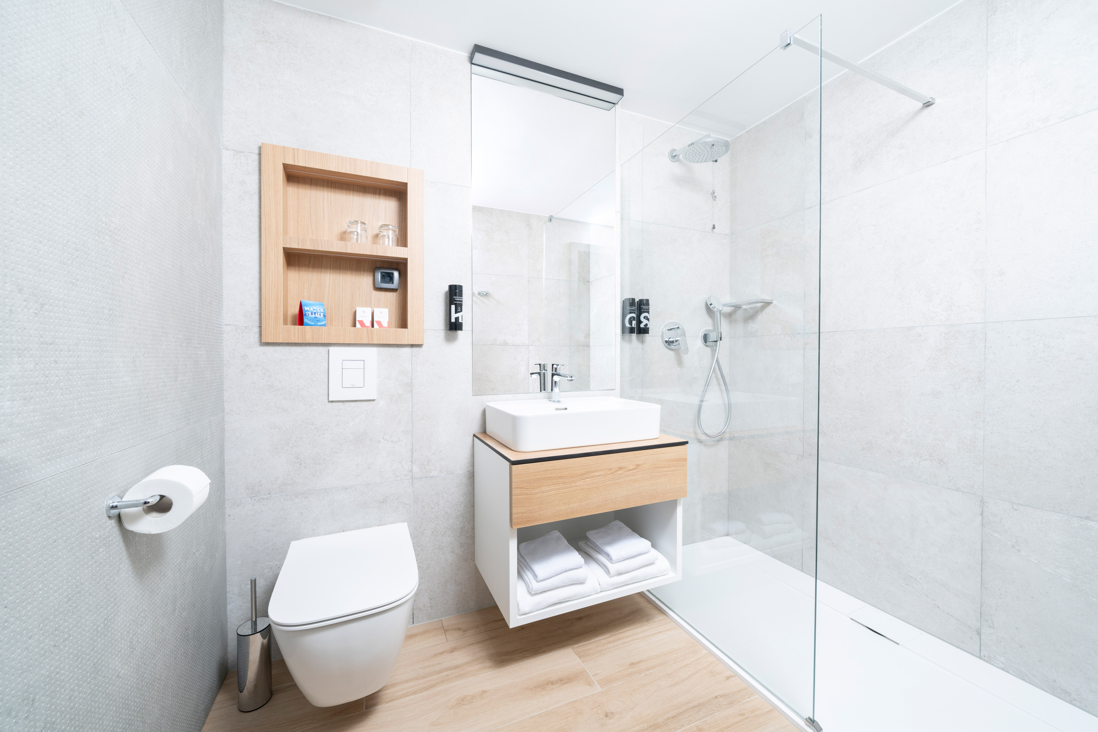 a bathroom with a glass shower and sink
