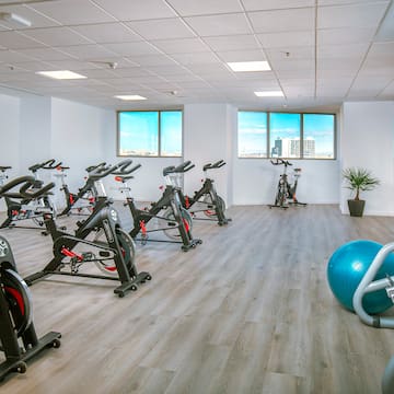a room with exercise bikes and a ball