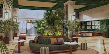 a room with a couch and plants