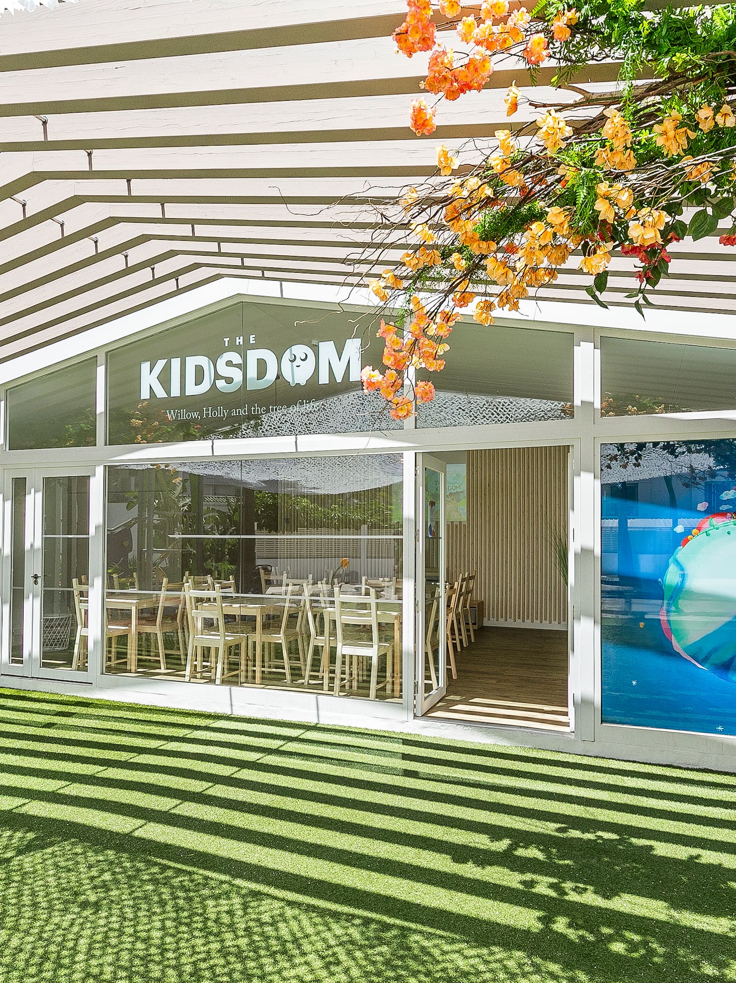 a building with a green lawn and a white awning