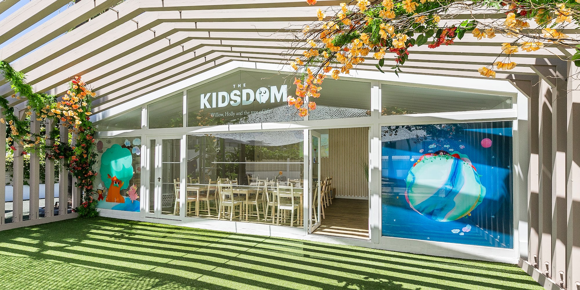 a building with a green lawn and a white awning