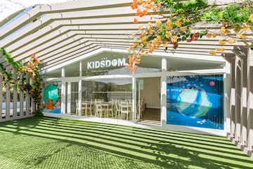 a building with a green lawn and a white awning