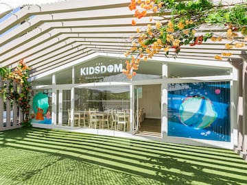 a building with a green lawn and a white awning