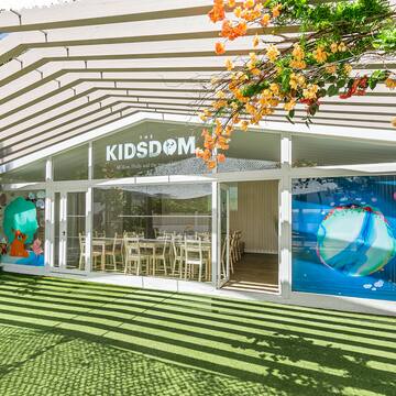 a building with a green lawn and a white awning