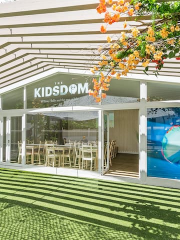 a building with a green lawn and a white awning