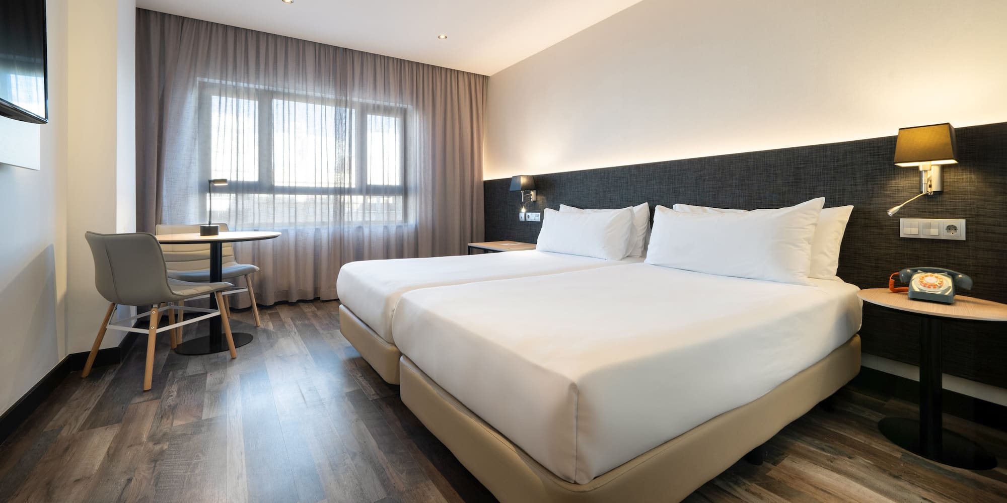 a room with two beds and a table