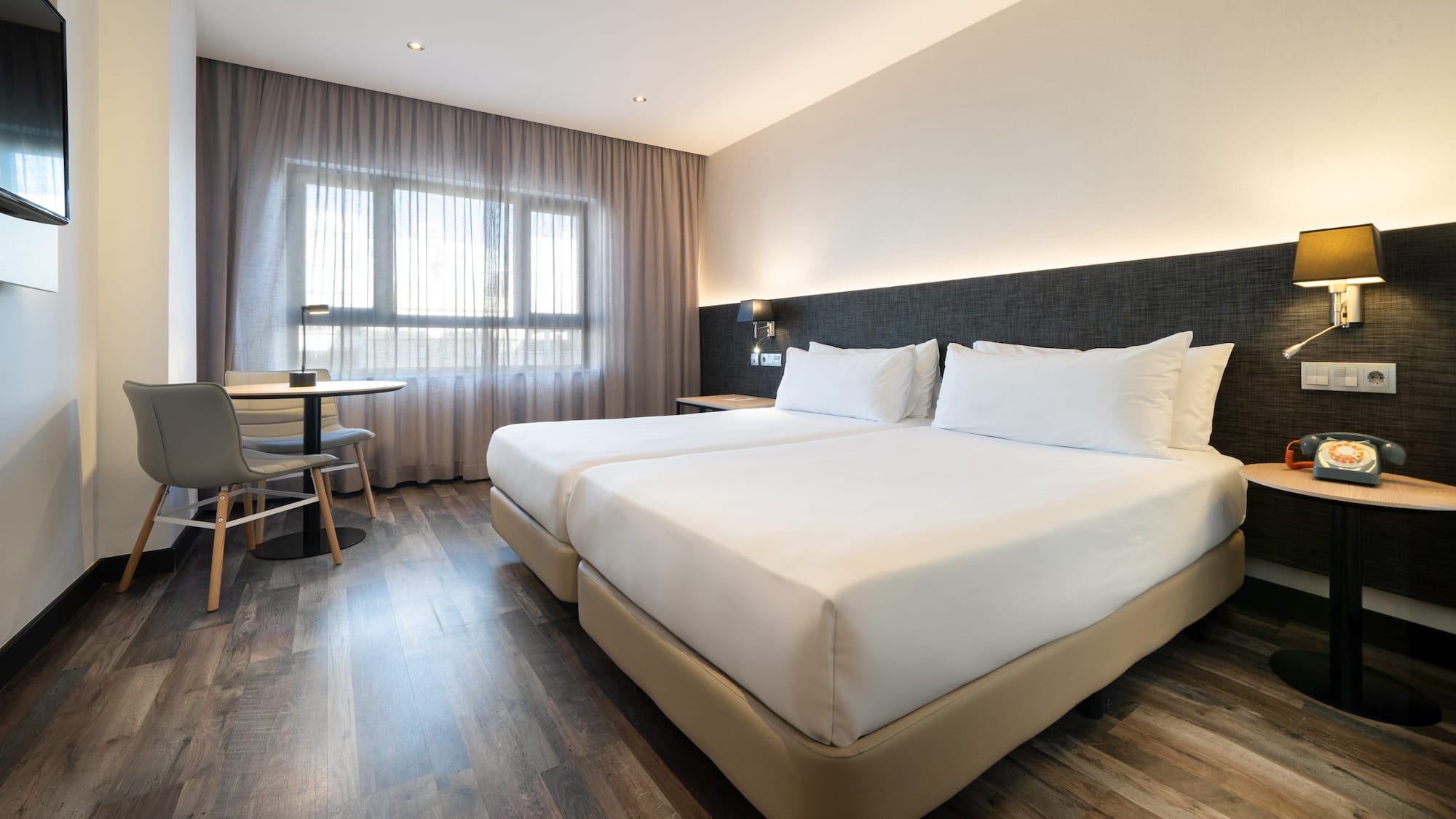 a room with two beds and a table