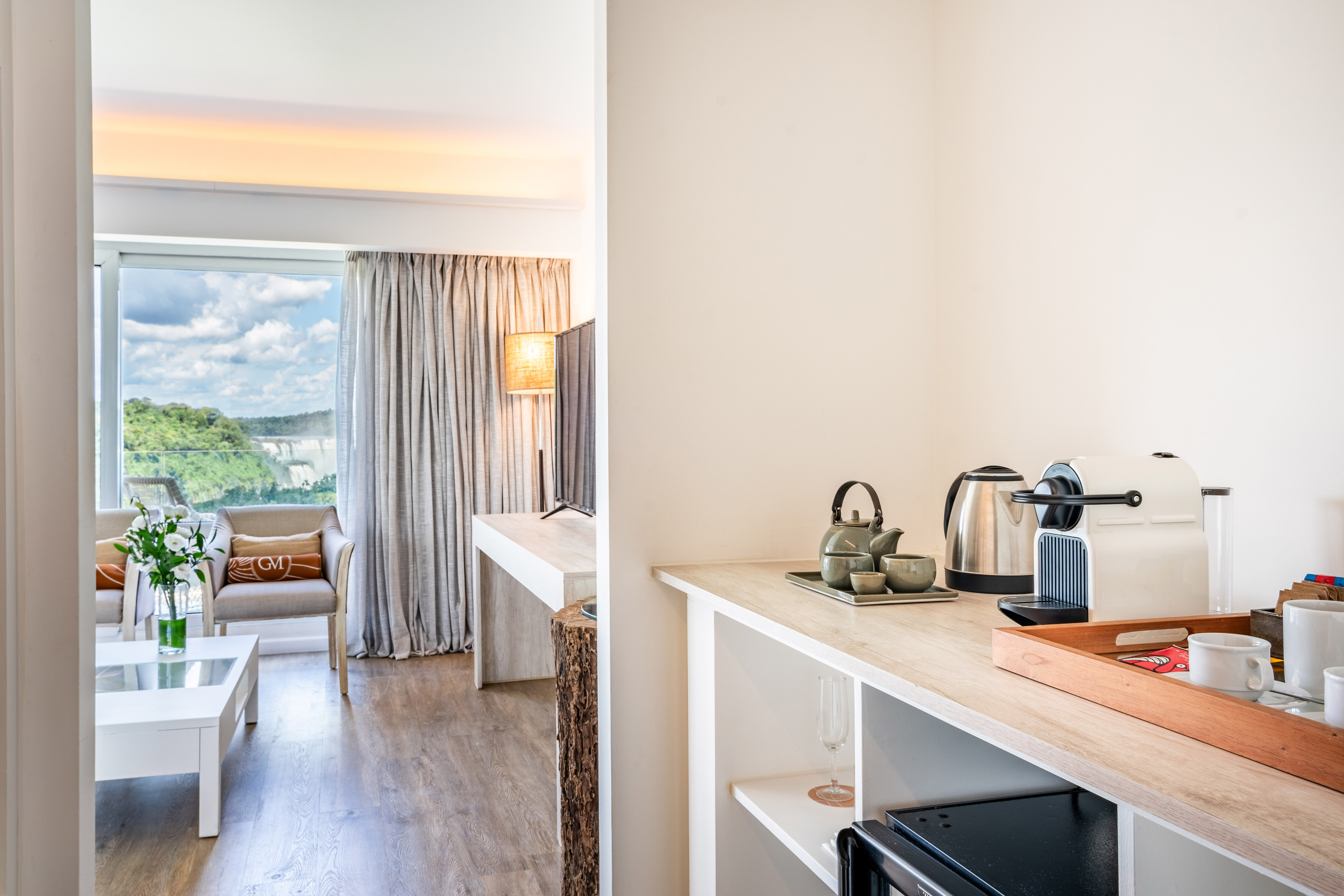 Luxury hotel suite: Iguazu Falls view, coffee machine, elegant lounge.