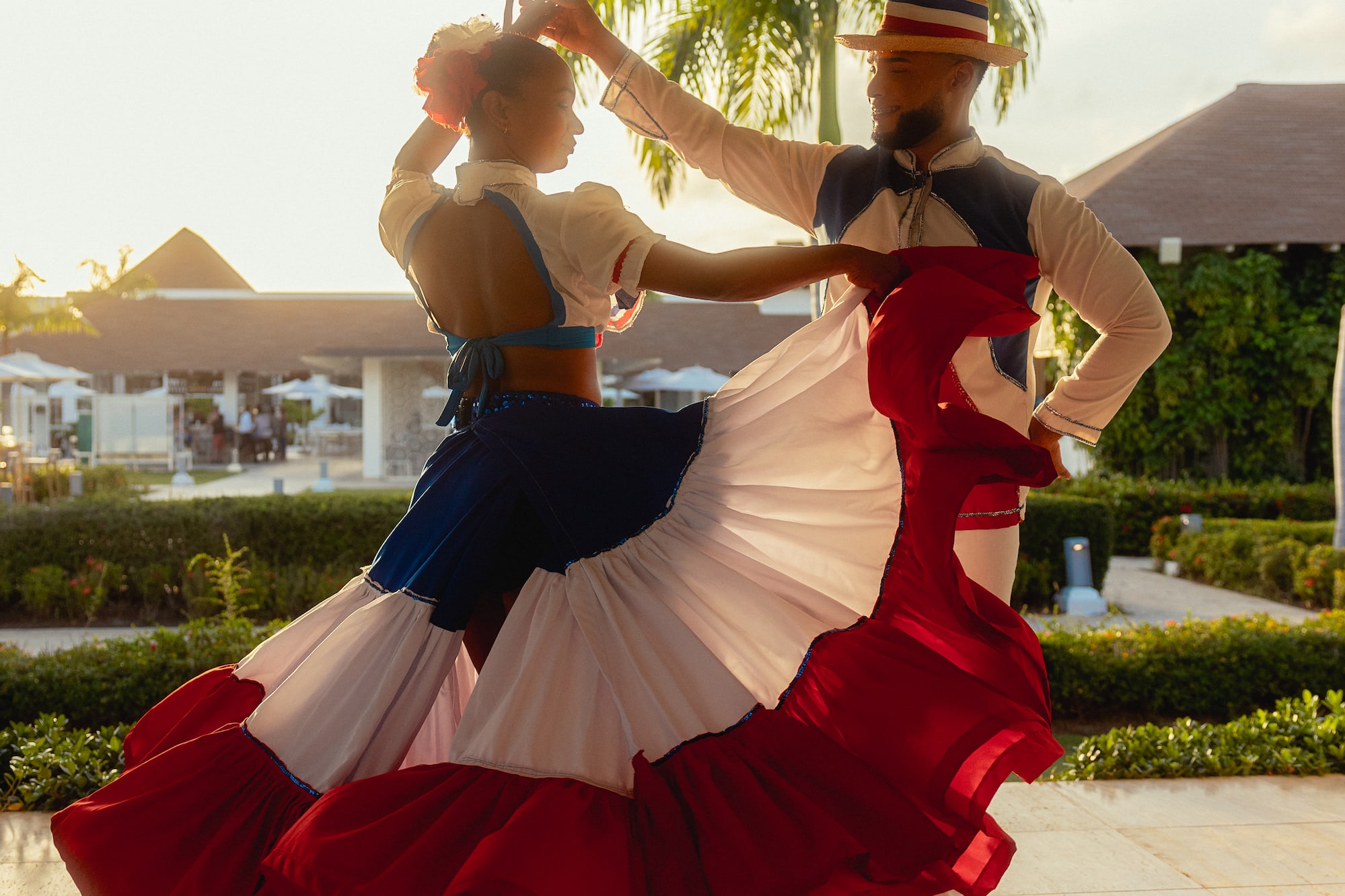 a man and woman dancing in a red white and blue dress